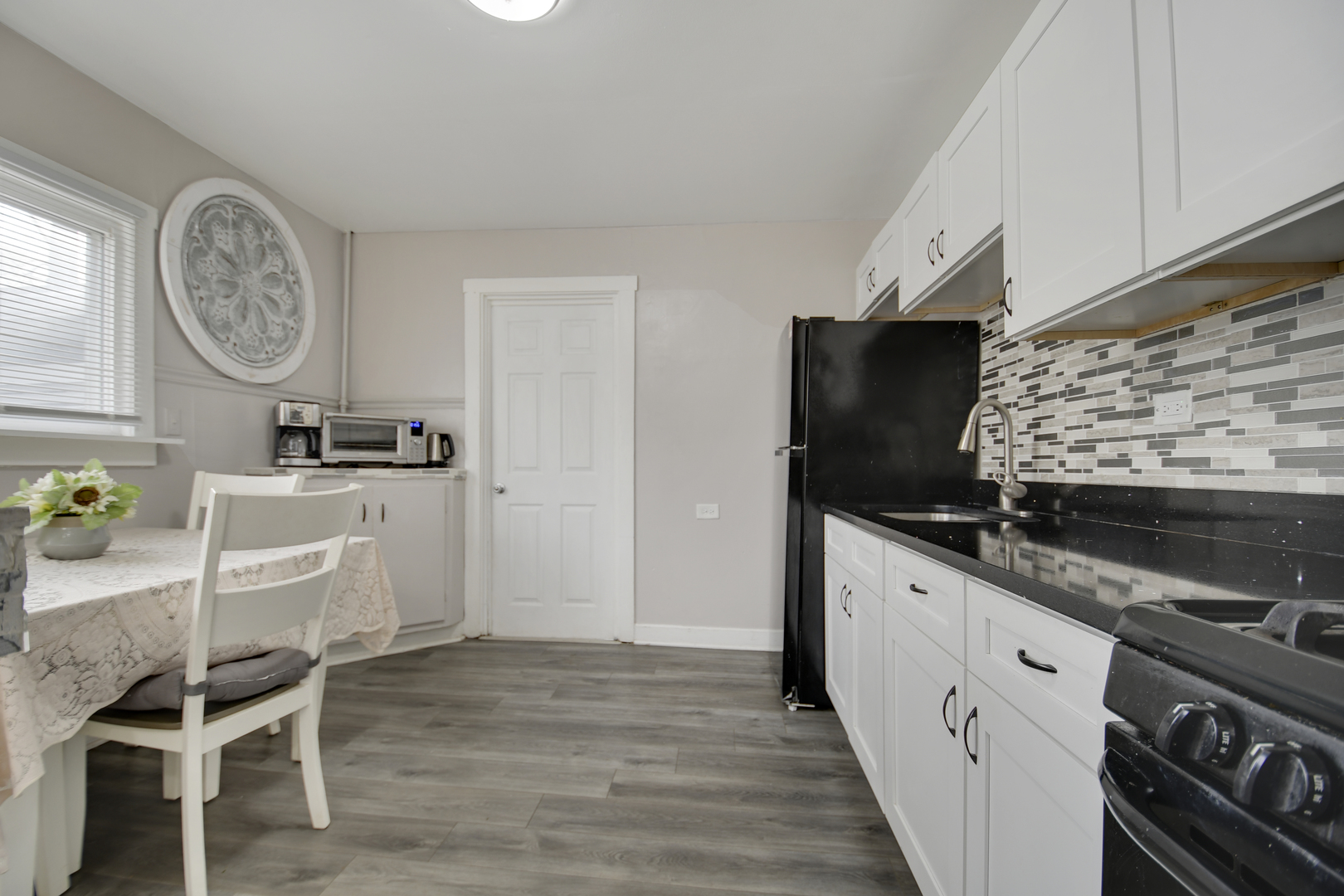 3737 Rose Manor Terrace Markham, IL 60428 - Photo 6 of 19 a kitchen with stainless steel appliances granite countertop a stove and a wooden floor