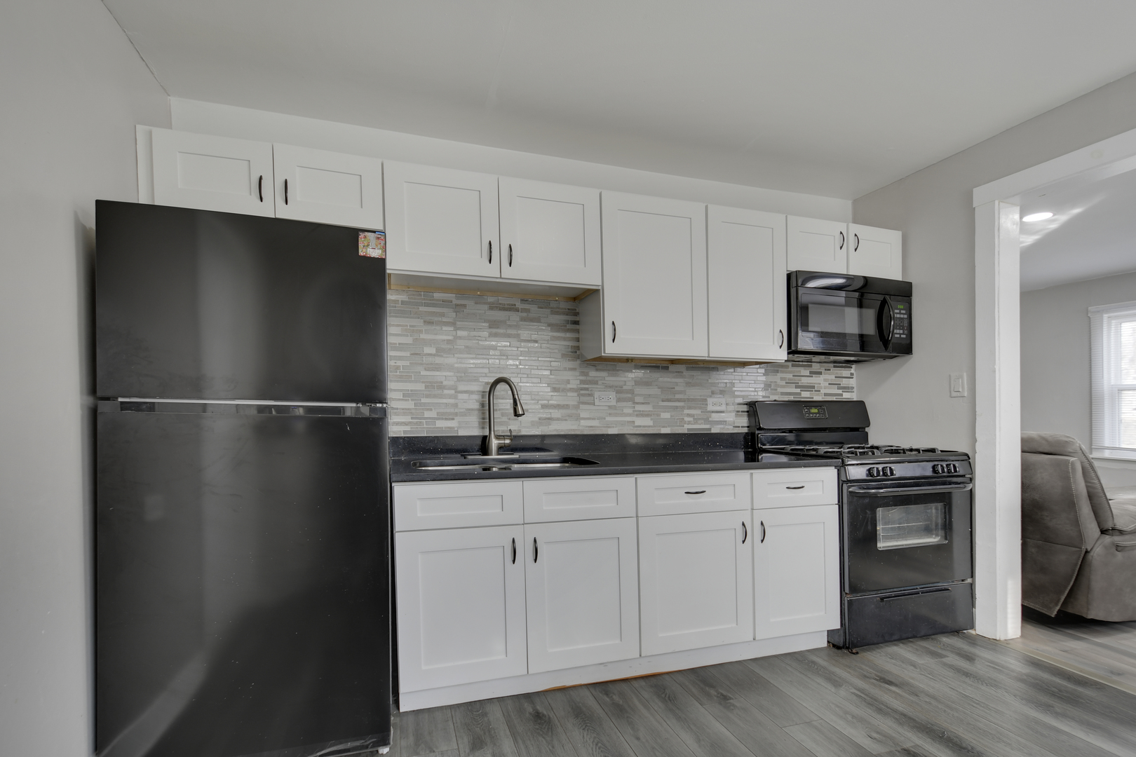 3737 Rose Manor Terrace Markham, IL 60428 - Photo 8 of 19 a kitchen with a sink a refrigerator and cabinets