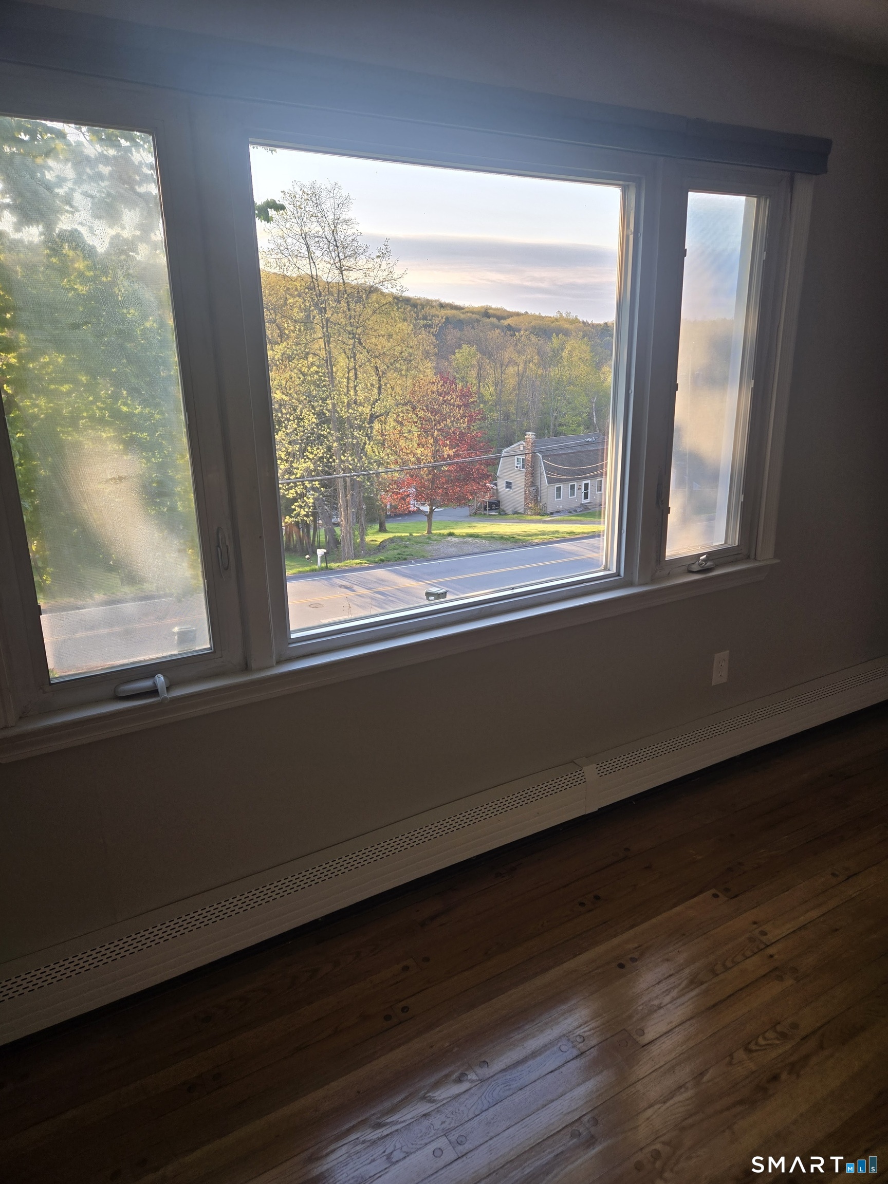 1004 Hickory Hill Road Thomaston, CT 06787 - Photo 16 of 23 a view of an empty room with wooden floor and a window