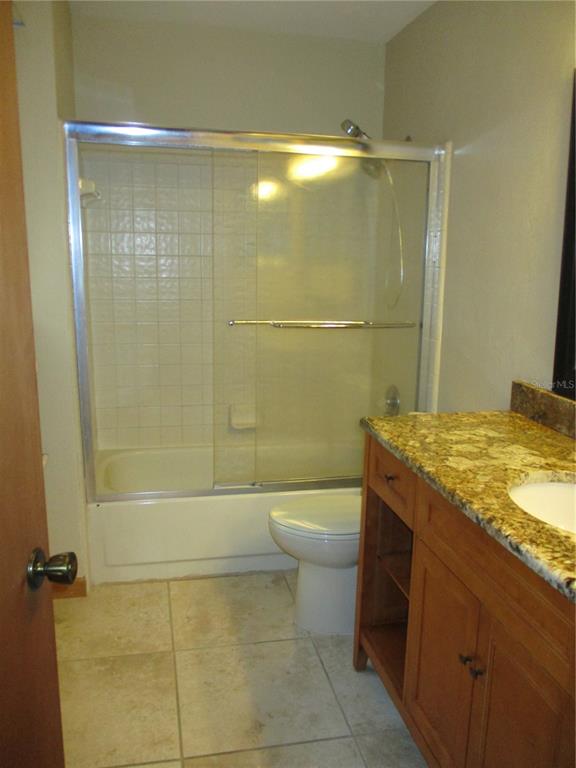 900 Southwest 62nd Boulevard, Unit D23 Gainesville, FL 32607 - Photo 15 of 37 a bathroom with a granite countertop sink a toilet and shower