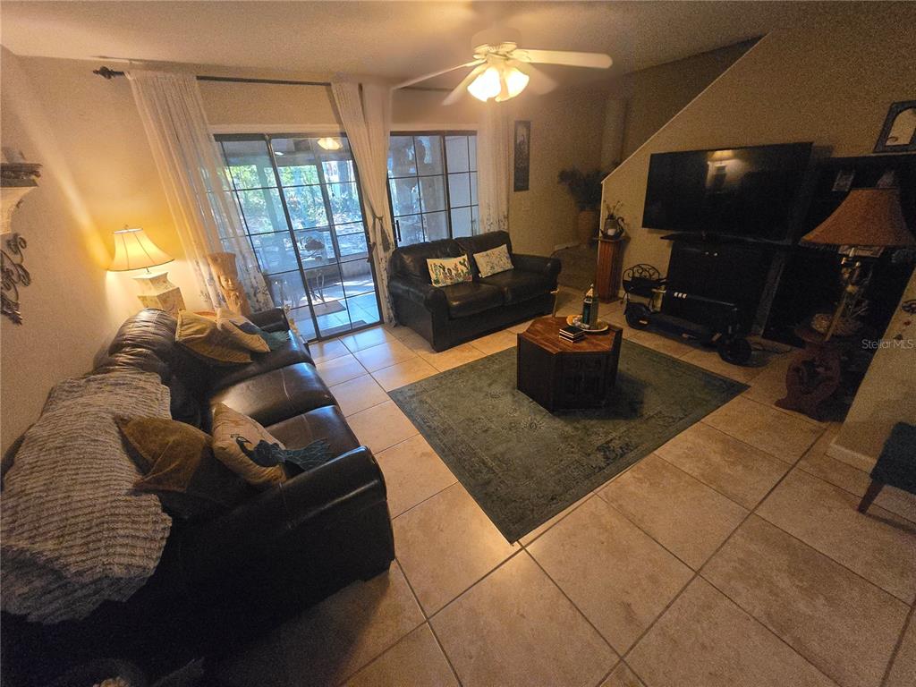 900 Southwest 62nd Boulevard, Unit D23 Gainesville, FL 32607 - Photo 30 of 37 a living room with furniture and a flat screen tv