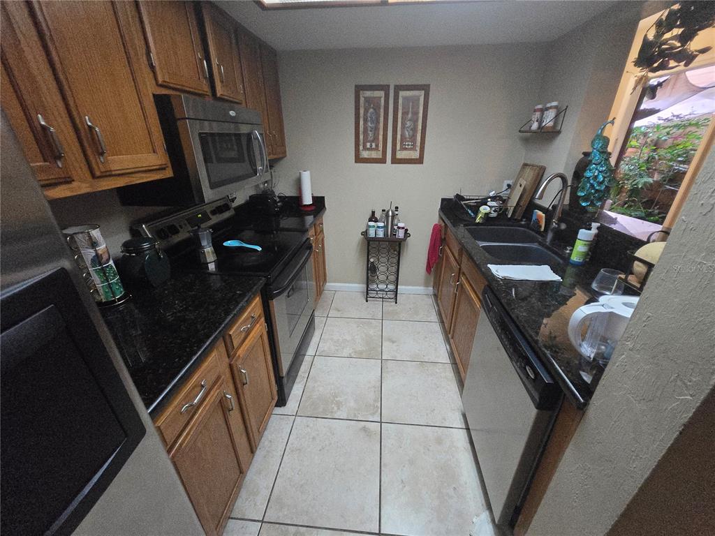 900 Southwest 62nd Boulevard, Unit D23 Gainesville, FL 32607 - Photo 31 of 37 a kitchen with sink stove and cabinets