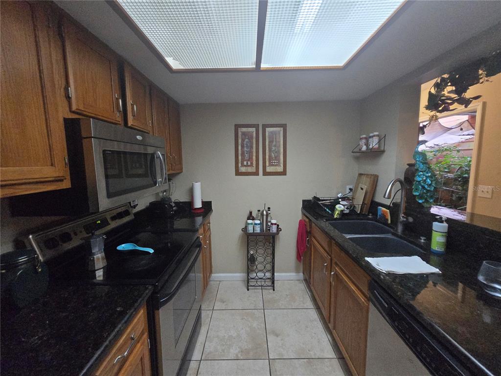 900 Southwest 62nd Boulevard, Unit D23 Gainesville, FL 32607 - Photo 32 of 37 a kitchen with a sink stove and microwave