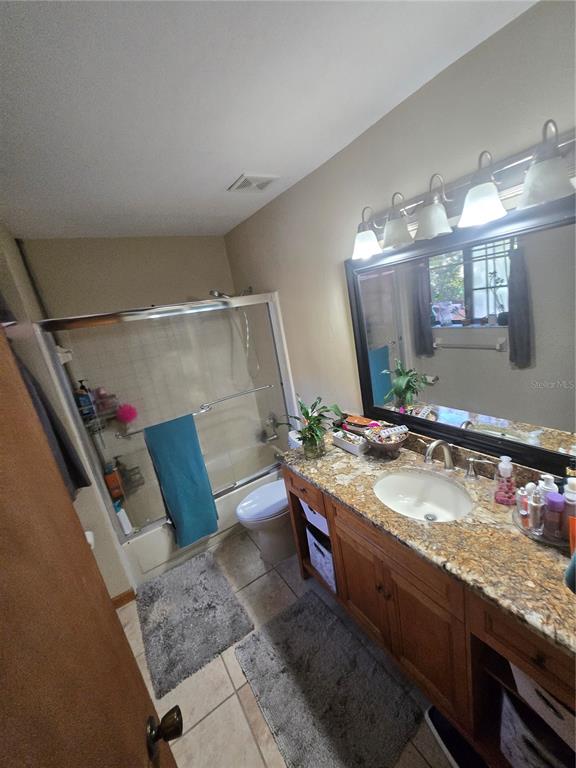 900 Southwest 62nd Boulevard, Unit D23 Gainesville, FL 32607 - Photo 37 of 37 a bathroom with a granite countertop sink and a mirror
