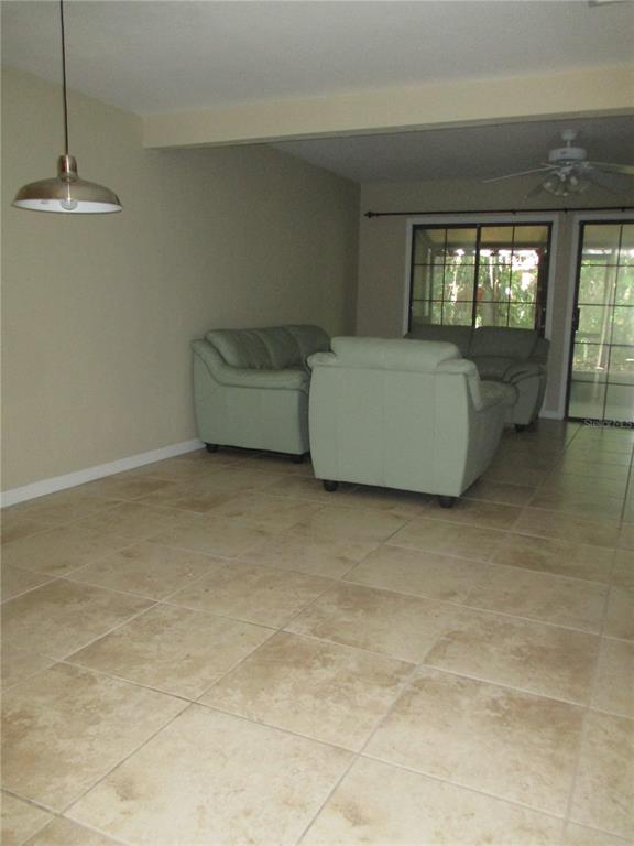 900 Southwest 62nd Boulevard, Unit D23 Gainesville, FL 32607 - Photo 8 of 37 a living room with couches and chandelier