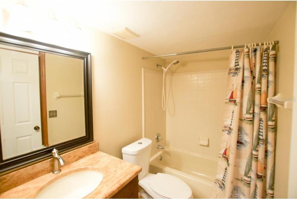 900 Southwest 62nd Boulevard, Unit D23 Gainesville, FL 32607 - Photo 10 of 37 a bathroom with a granite countertop sink toilet and shower