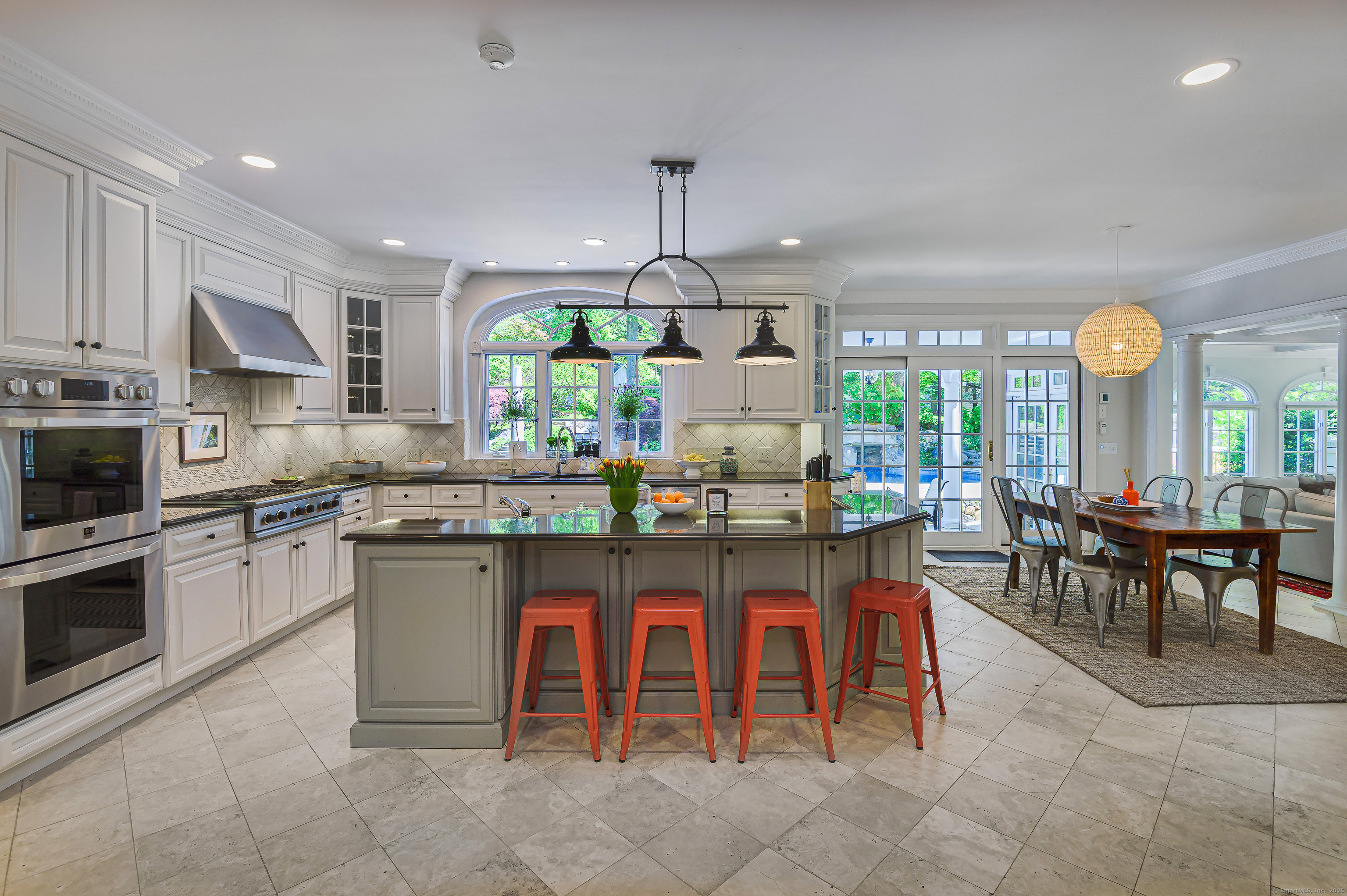 134 Nod Road Ridgefield, CT 06877 - Photo 14 of 40 a kitchen with granite countertop a sink dining table and chairs
