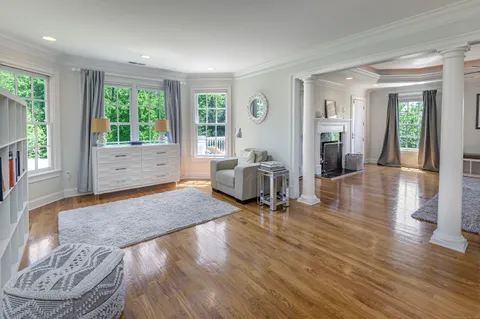 a living room with furniture and large windows
