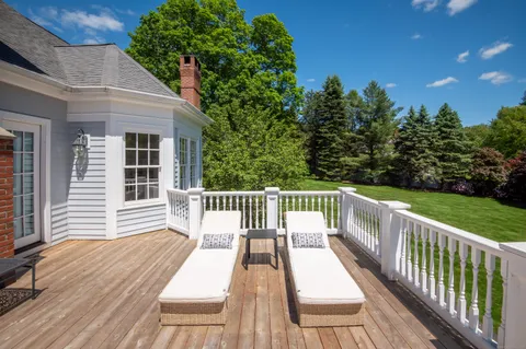 a view of balcony with wooden floor and fence