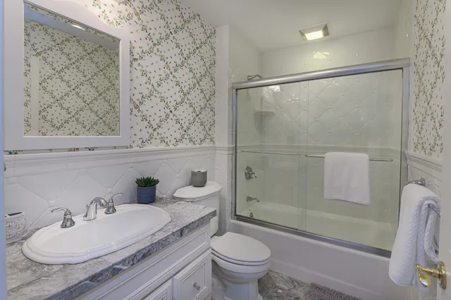 a bathroom with a sink toilet and shower