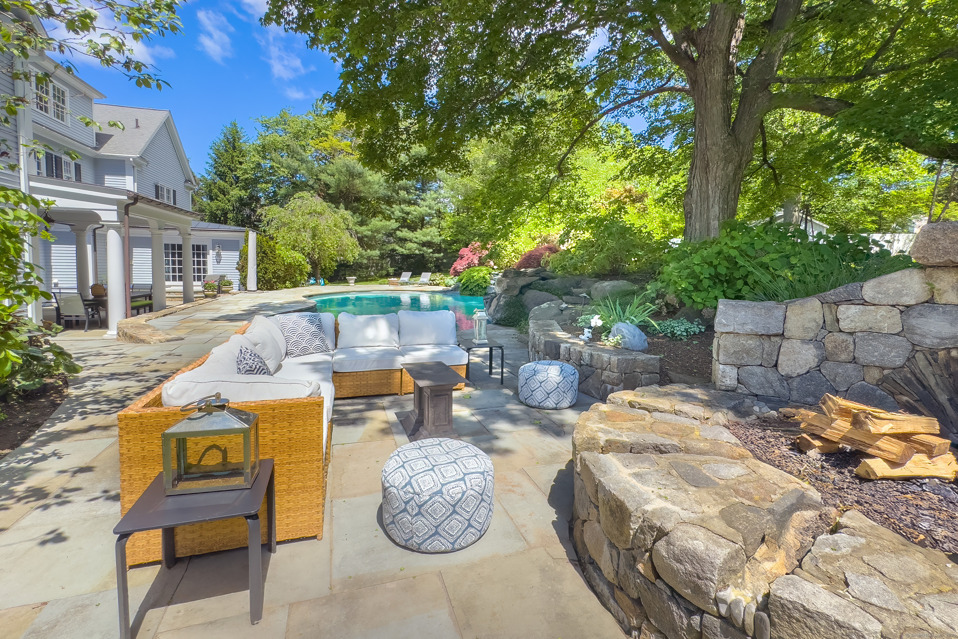 134 Nod Road Ridgefield, CT 06877 - Photo 5 of 40 a view of a patio with table and chairs potted plants and large tree
