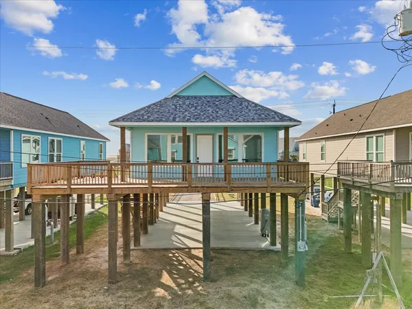 a view of a house with backyard porch and sitting area
