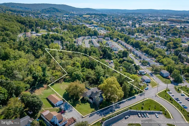 an aerial view of a residential houses and city street