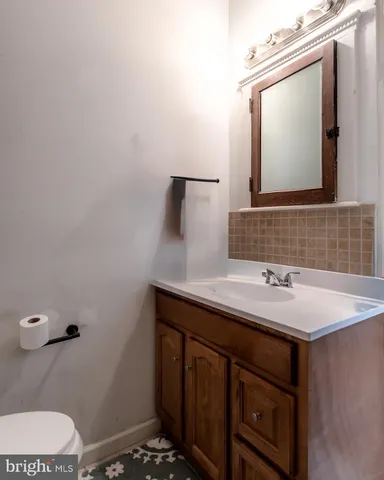 a bathroom with a sink toilet and mirror