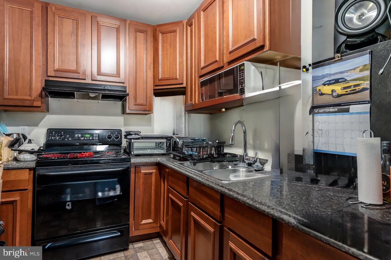 1220 Hay Road Temple, PA 19560 - Photo 20 of 24 a kitchen with stainless steel appliances granite countertop a stove and a sink