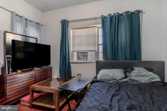 a bedroom with a bed and flat screen tv