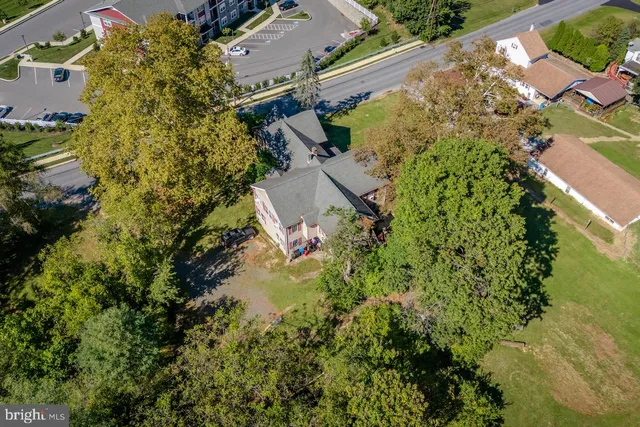 an aerial view of a house with a yard
