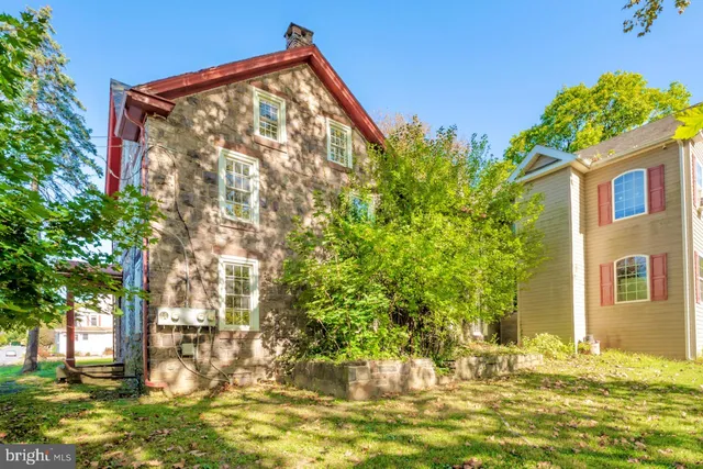 a view of a house with a large tree