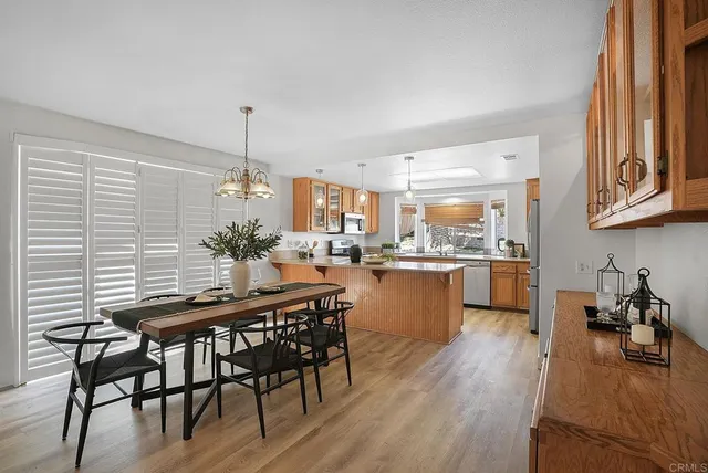 a view of a dining room with furniture and wooden floor