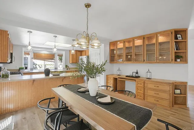 a bathroom with a granite countertop sink a toilet and a mirror