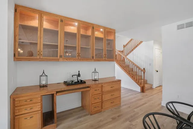 a view of staircase with wooden floor and white walls