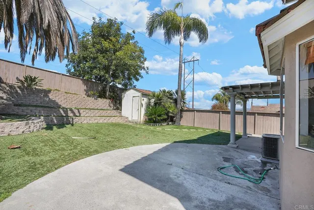 a front view of a house with a yard and potted plants