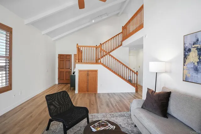 a dining room with stainless steel appliances kitchen island granite countertop furniture and wooden floor