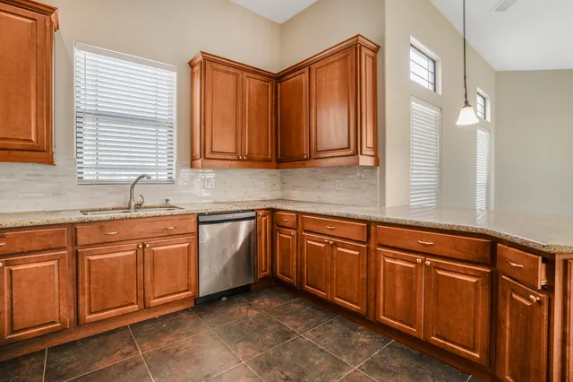a kitchen with stainless steel appliances granite countertop a sink and a cabinets