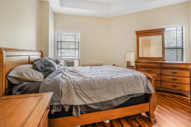 a bed sitting in a bedroom next to a window