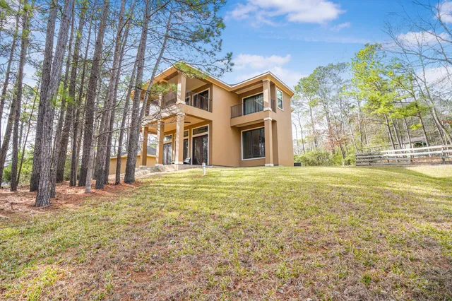 a grassy field with trees in the background