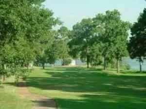 a wooden pier with boats in a lake