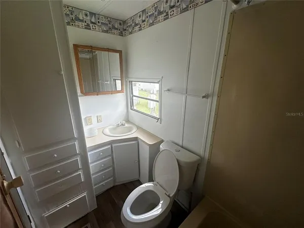 a bathroom with a toilet and a sink