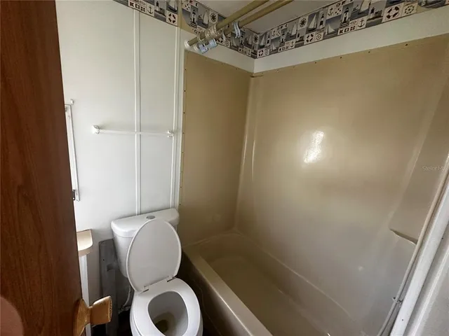 a bathroom with a toilet and shower