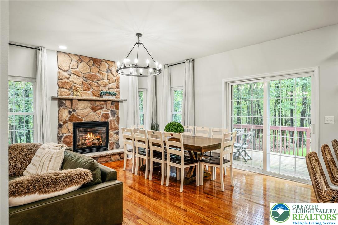 117 Ridge Road Pocono Lake, PA 18347 - Photo 14 of 41 a living room with furniture a fireplace and a floor to ceiling window