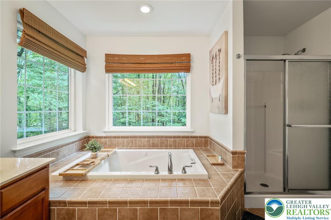 117 Ridge Road Pocono Lake, PA 18347 - Photo 30 of 41 a bath tub sitting in a bathroom next to a window