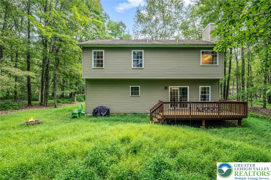 117 Ridge Road Pocono Lake, PA 18347 - Photo 3 of 41 a view of a backyard with table and chairs a barbeque