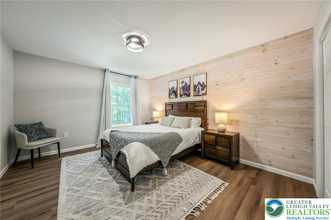 117 Ridge Road Pocono Lake, PA 18347 - Photo 36 of 41 a bedroom with a bed and wooden floor