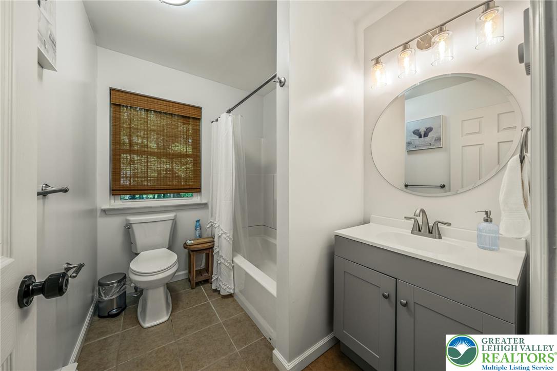 117 Ridge Road Pocono Lake, PA 18347 - Photo 39 of 41 a bathroom with a toilet sink and mirror
