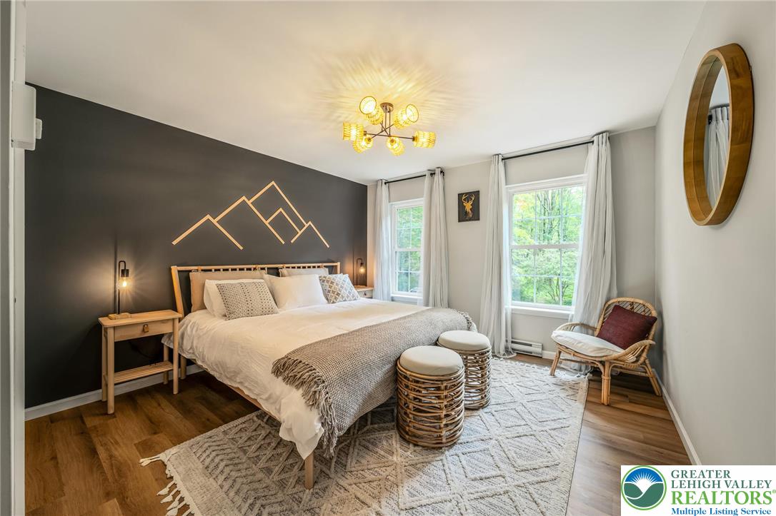 117 Ridge Road Pocono Lake, PA 18347 - Photo 40 of 41 a bedroom with a bed and a chandelier