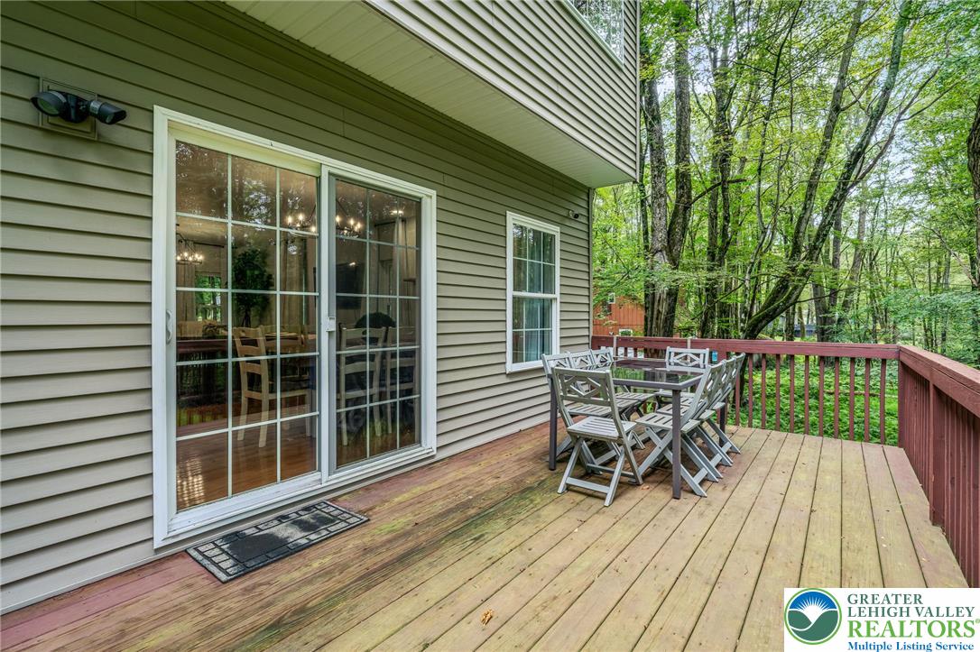117 Ridge Road Pocono Lake, PA 18347 - Photo 4 of 41 a view of a deck with table and chairs and wooden floor