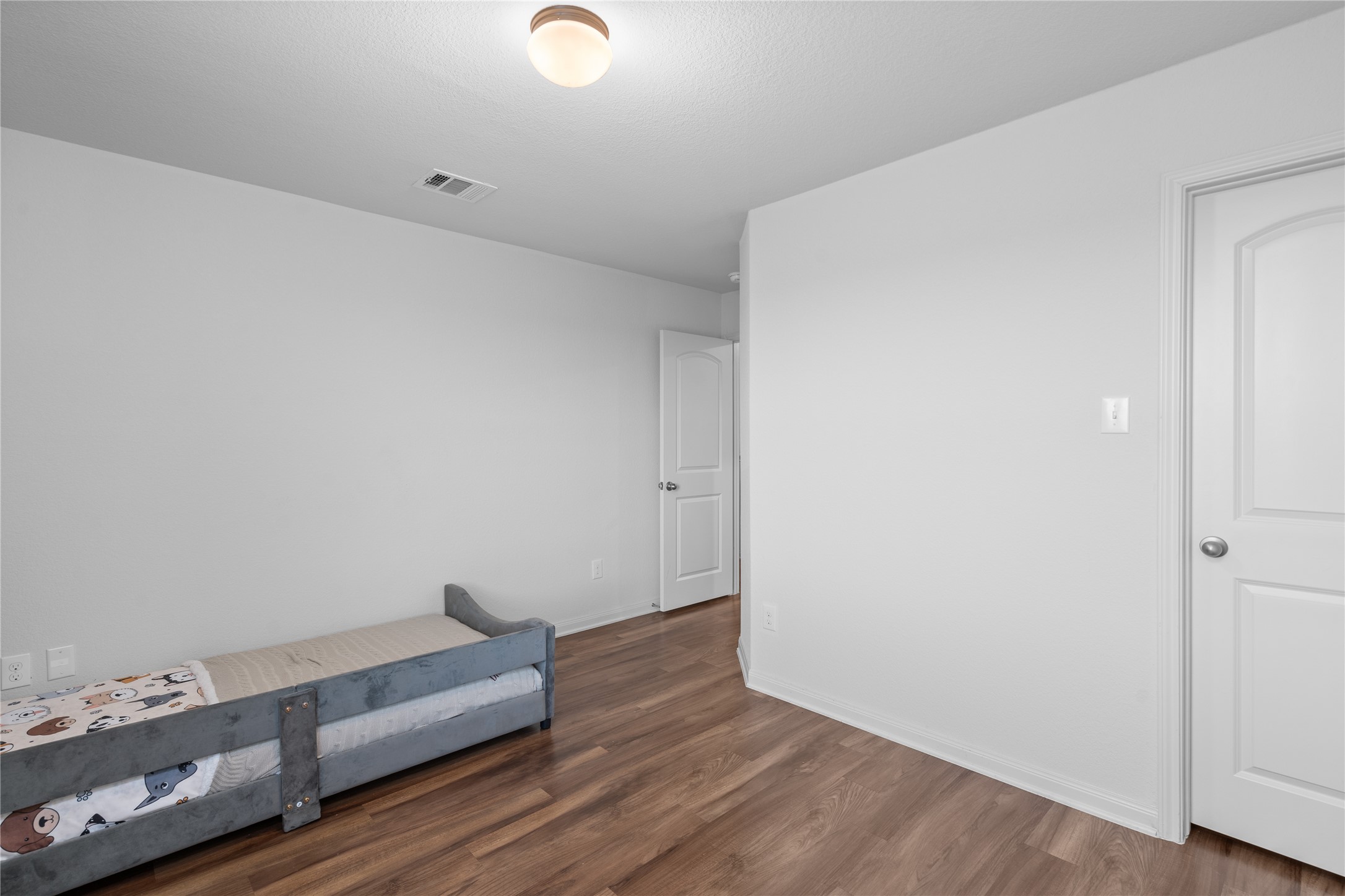20205 Grover Cleveland Way Manor, TX 78653 - Photo 22 of 26 a view of room with hardwood floor