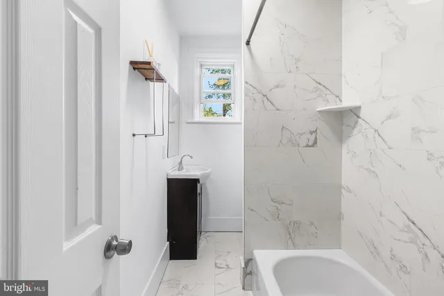 a bathroom with a bathtub and shower