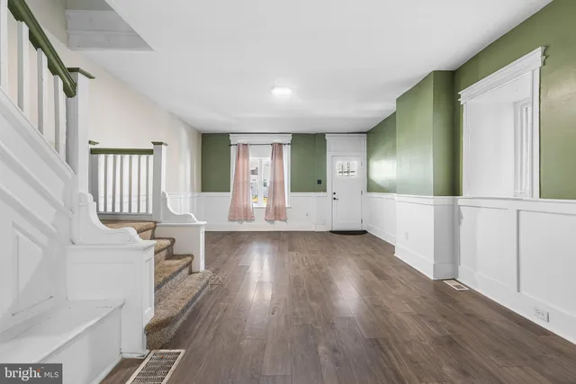 wooden floor in an empty room with a window