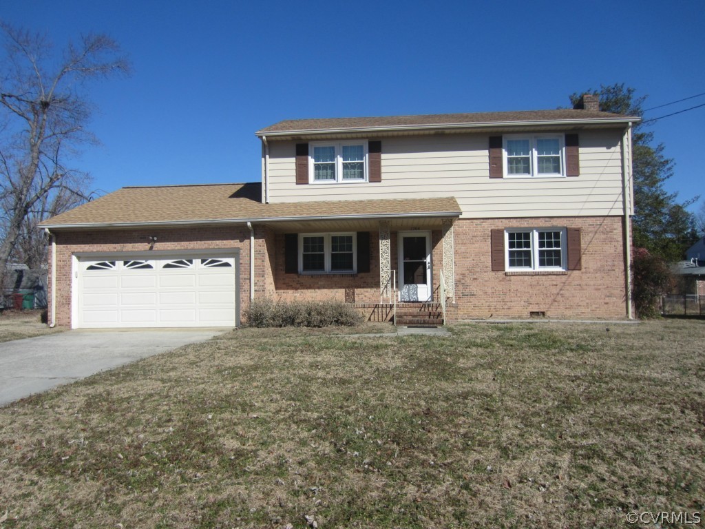 1204 Covington Road Colonial Heights, VA 23834 - Photo 1 of 2 a front view of a house with a yard and garage