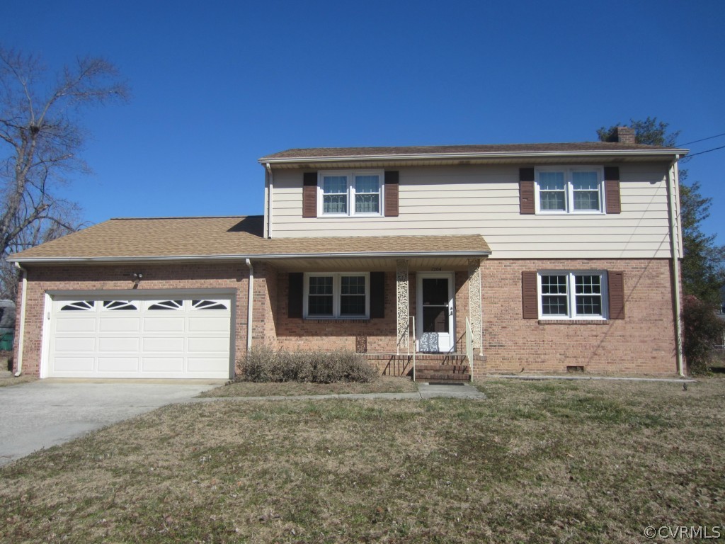 1204 Covington Road Colonial Heights, VA 23834 - Photo 2 of 2 a front view of a house with a yard and garage