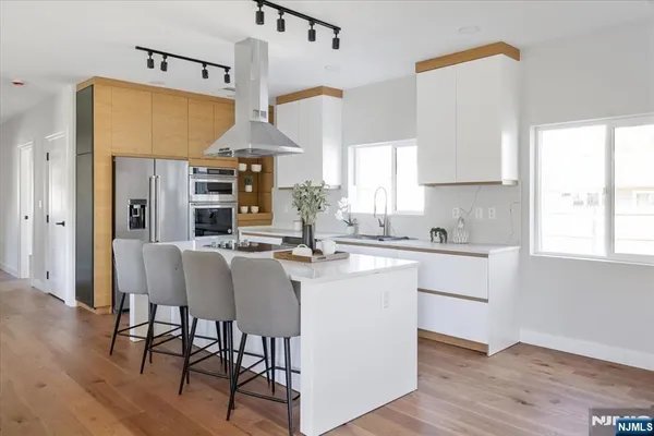 a kitchen with a table chairs microwave and cabinets