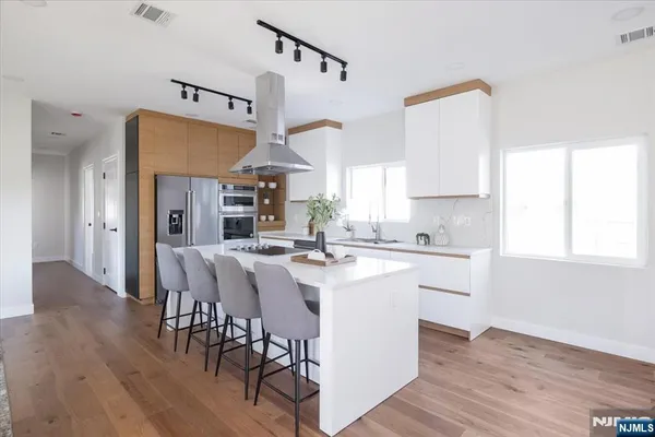 a bathroom with a double vanity sink mirror and shower
