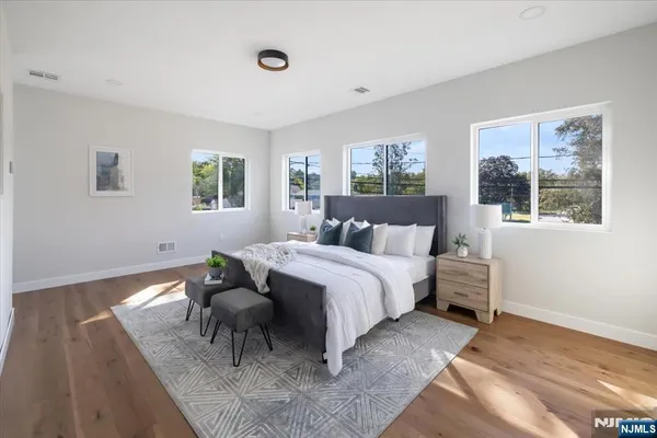 a bedroom with a bed and wooden floor