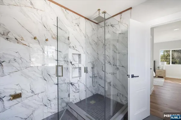 a spacious bathroom with a bathtub and shower