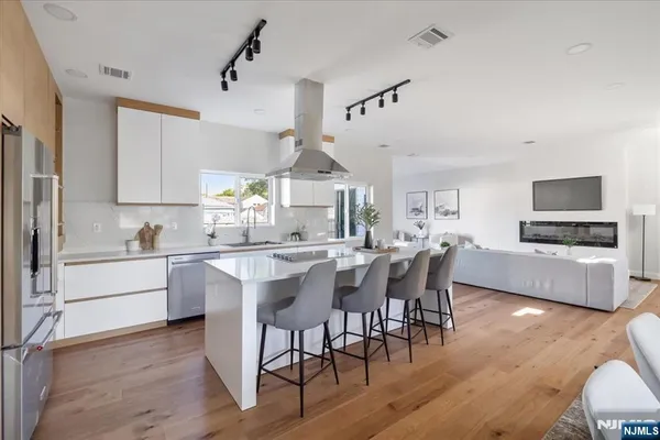 a living room with furniture and view of kitchen